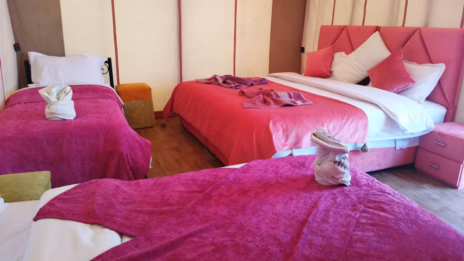 Comfortable desert tent accommodations with plush bedding, part of the 4-day tour from Fes via Merzouga.