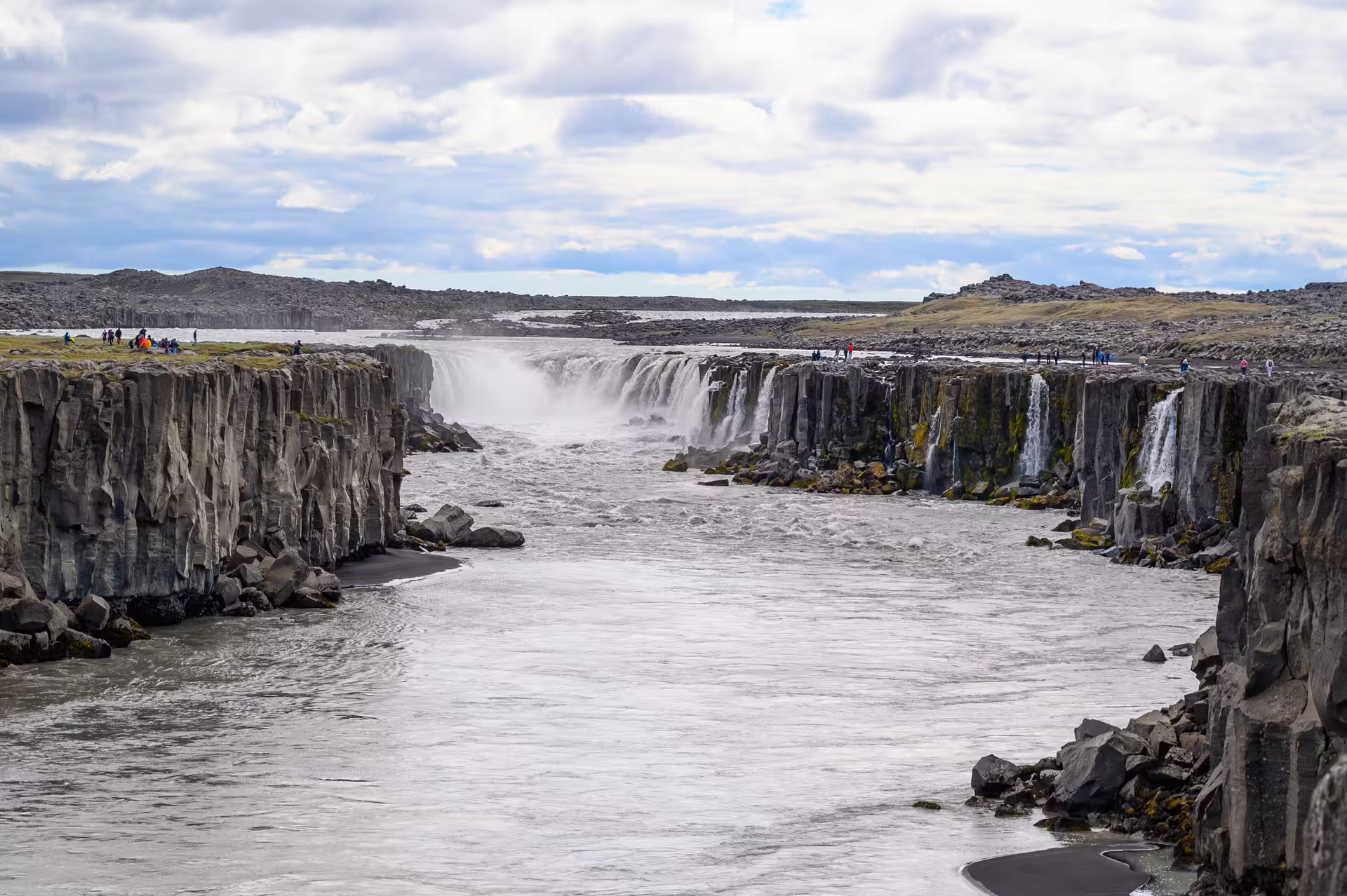 Dettifoss waterfall canyon with rushing glacial river and basalt rock walls in Iceland