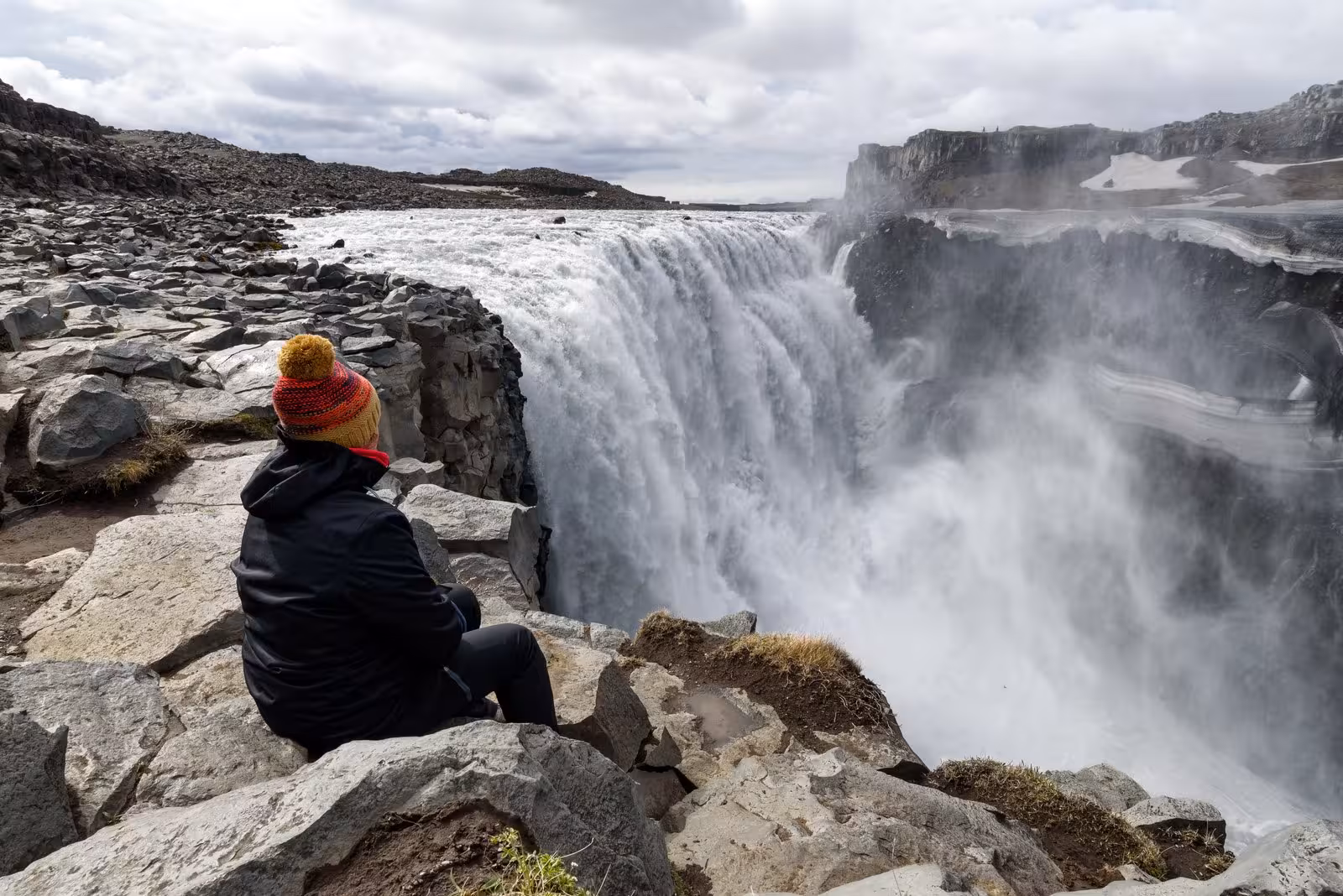 Traveler enjoying the view of Dettifoss waterfall on the Complete Iceland Circle 9-day self-drive adventure.