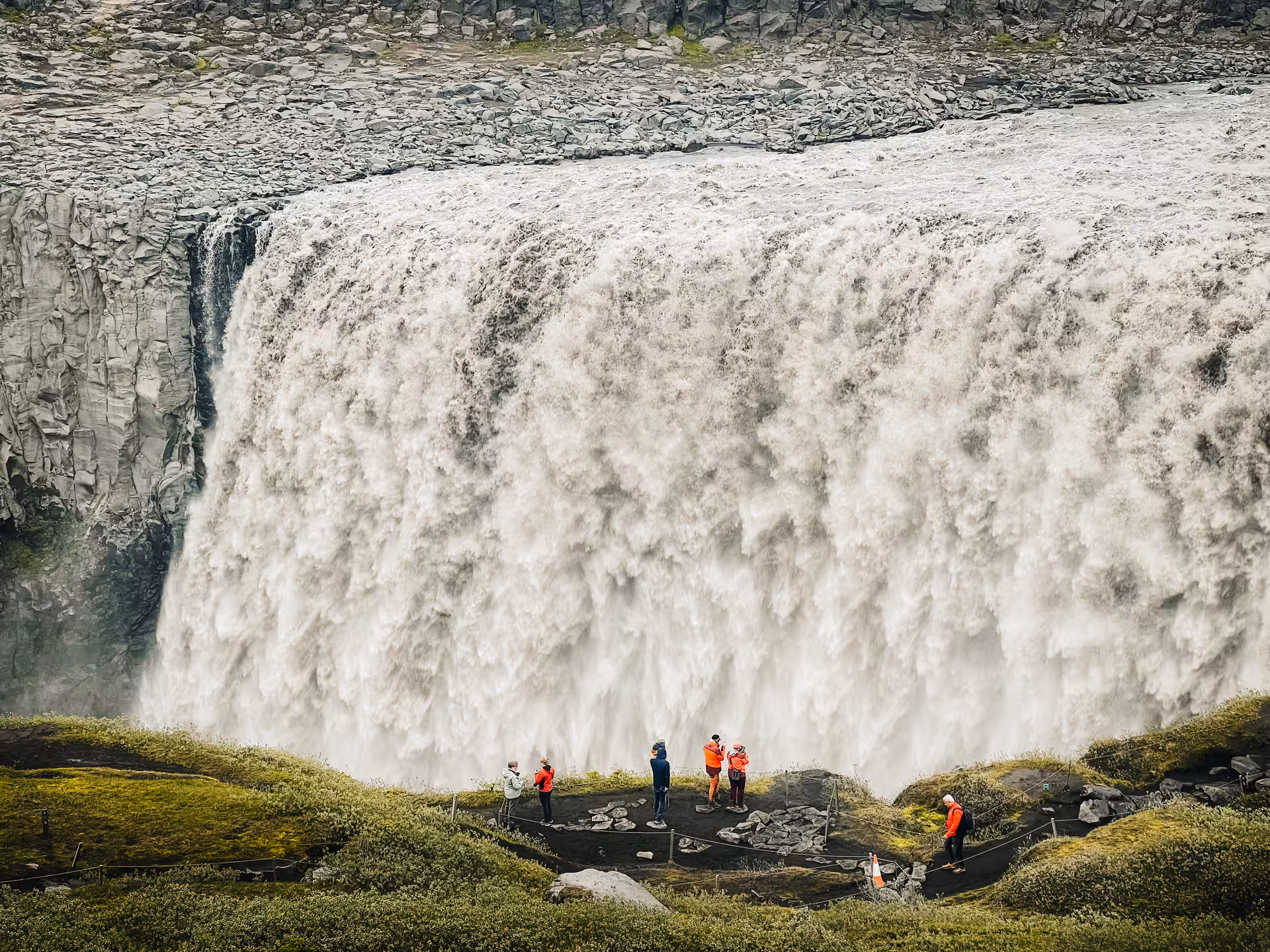 Visitors at Dettifoss viewpoint beside roaring falls on Iceland Diamond Circle tour in Vatnajökull National Park