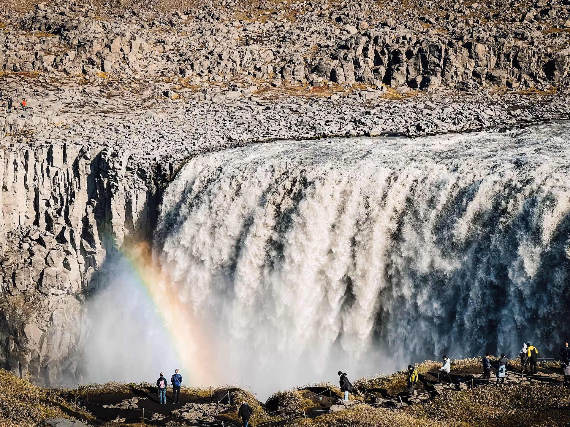 Close-up of Dettifoss waterfall with rainbow and viewing platforms on Iceland Diamond Circle day tour