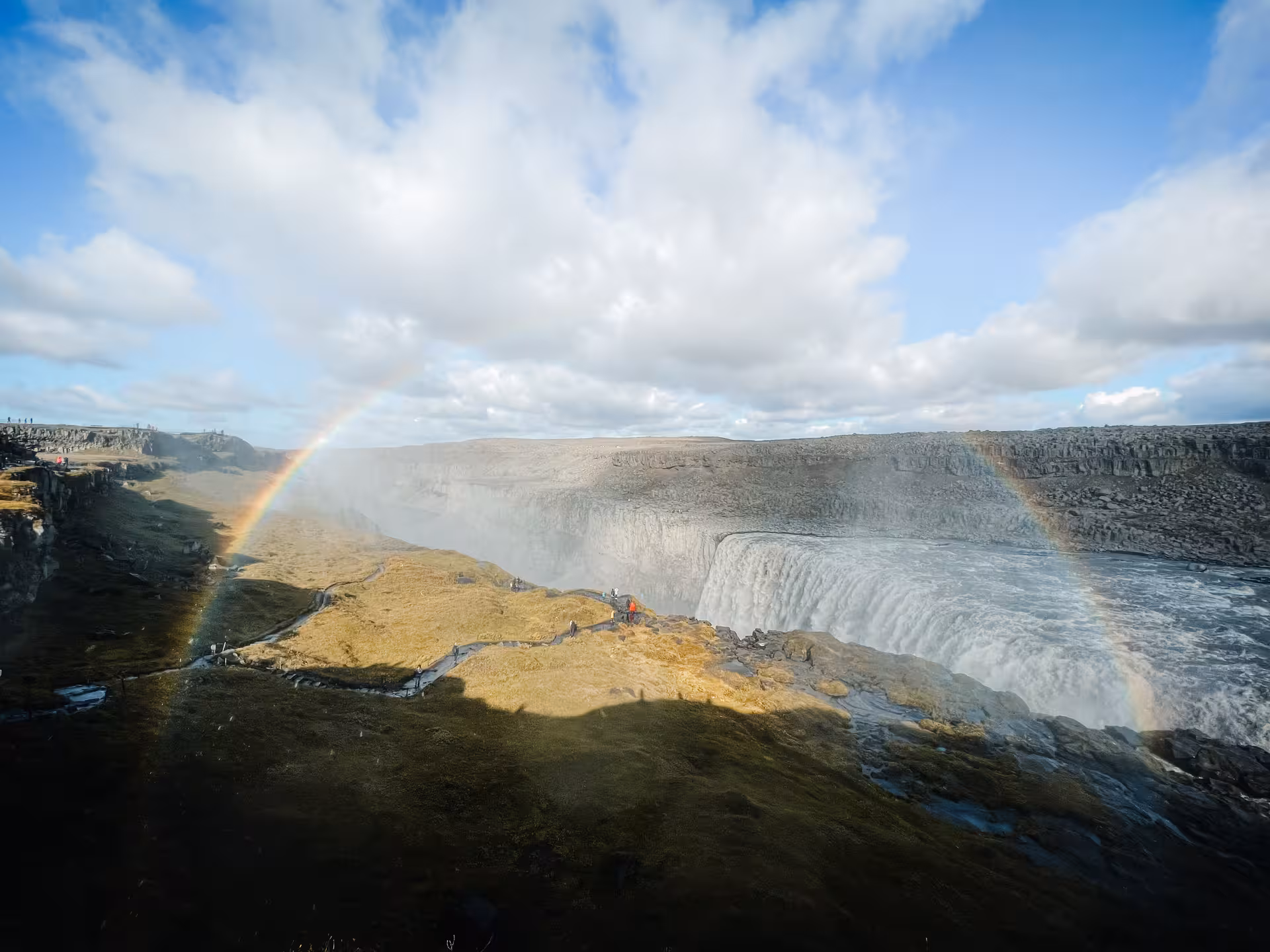 Rainbow over powerful Dettifoss waterfall in North Iceland, highlight of private Goðafoss and Lake Mývatn tour