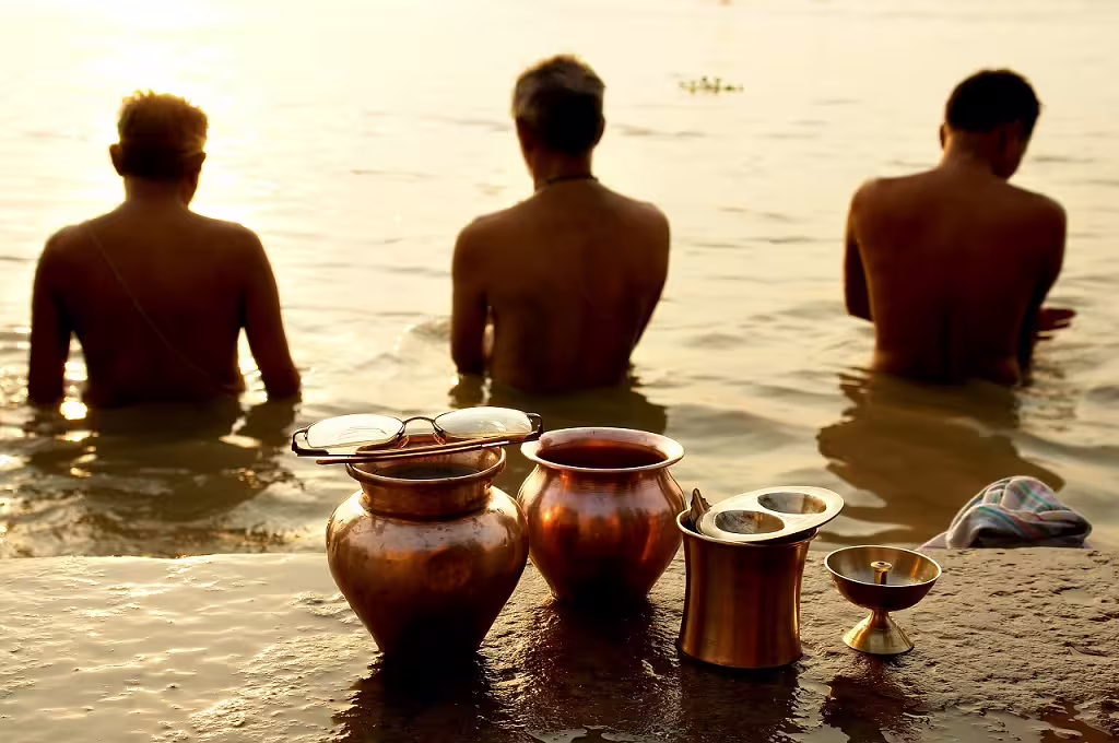 Devotees perform morning rituals in the sacred Ganges River, highlighting spiritual experiences in Classical North India.