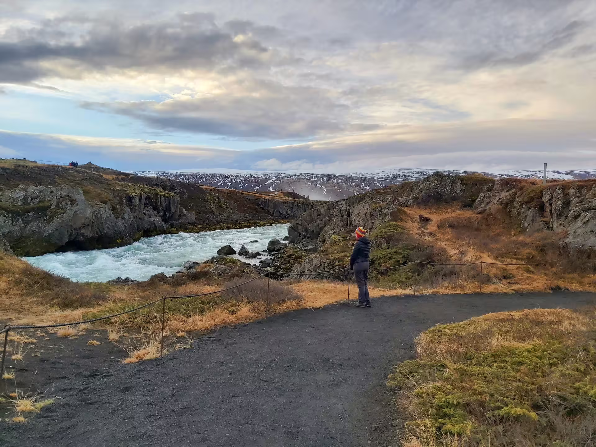 Tourist overlooking a glacial river canyon on the Diamond Circle tour in North Iceland