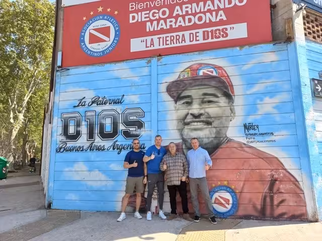 Guests in front of Argentinos Juniors Maradona stadium mural, La Paternal Buenos Aires Diego tour