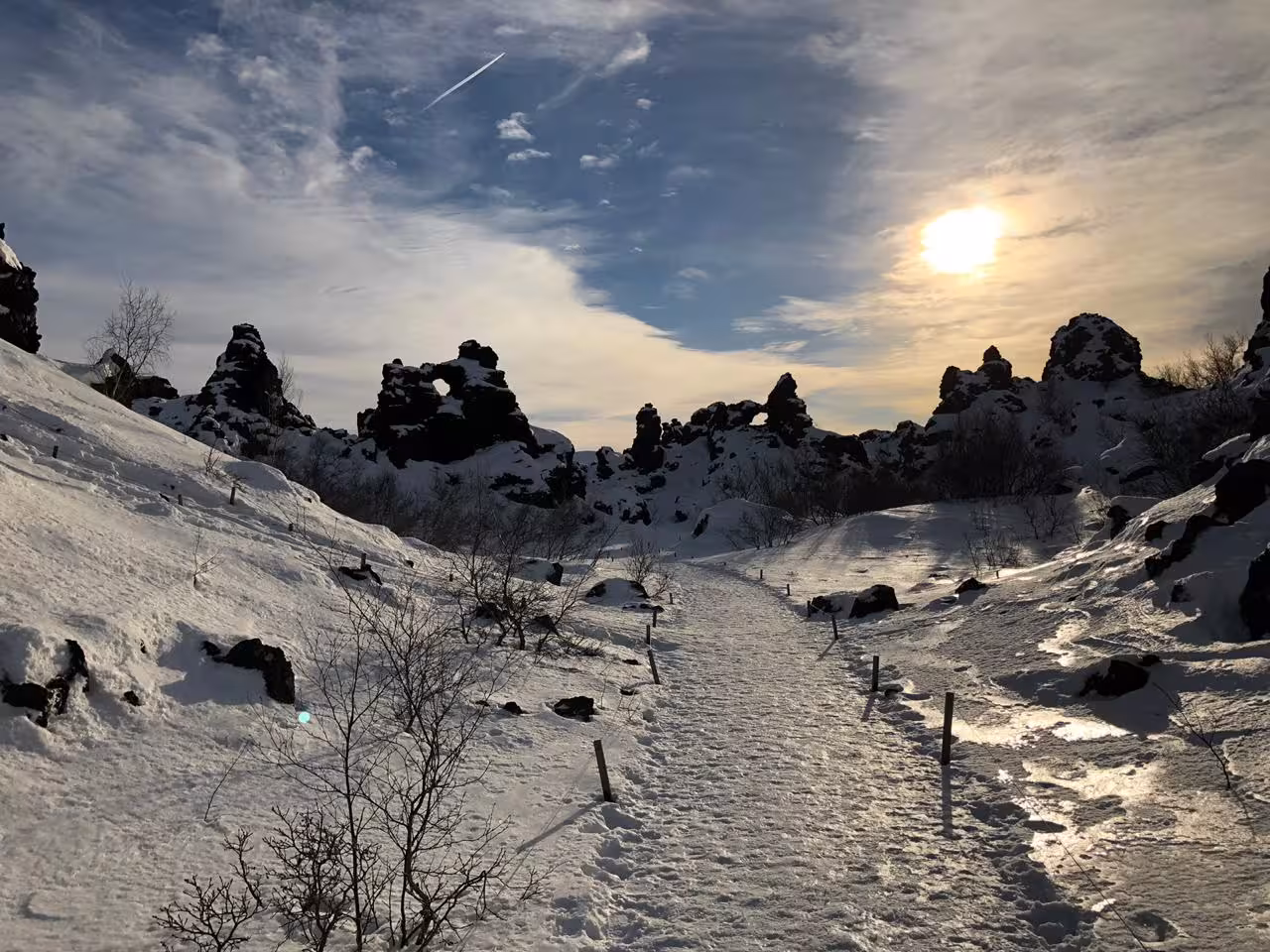 Snow-covered lava rock formations and winter trail at Dimmuborgir near Lake Myvatn guided nature experience Iceland