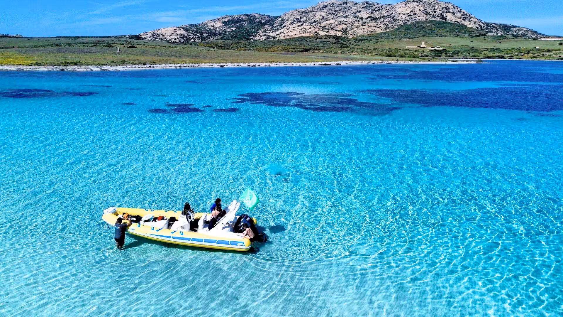 Dinghy anchored in the crystal-clear waters near Asinara, offering a scenic and serene exploration of the island's coastline.