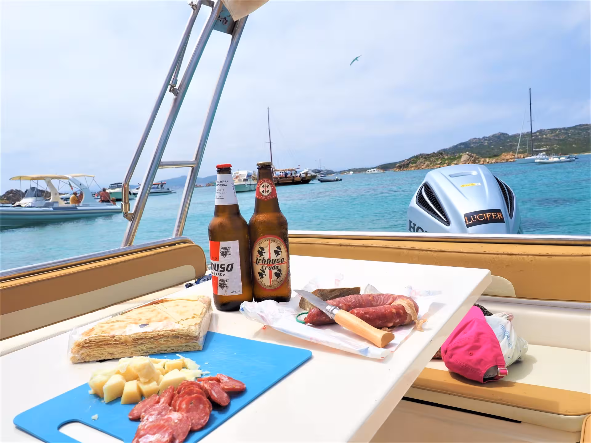 Enjoy a delicious spread with beer on a dinghy tour between the stunning beaches of La Maddalena, Palau.