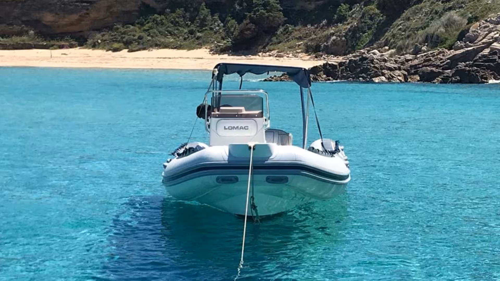 Anchored dinghy in crystal-clear waters off the scenic coastline of southern Corsica, perfect for a leisurely tour.