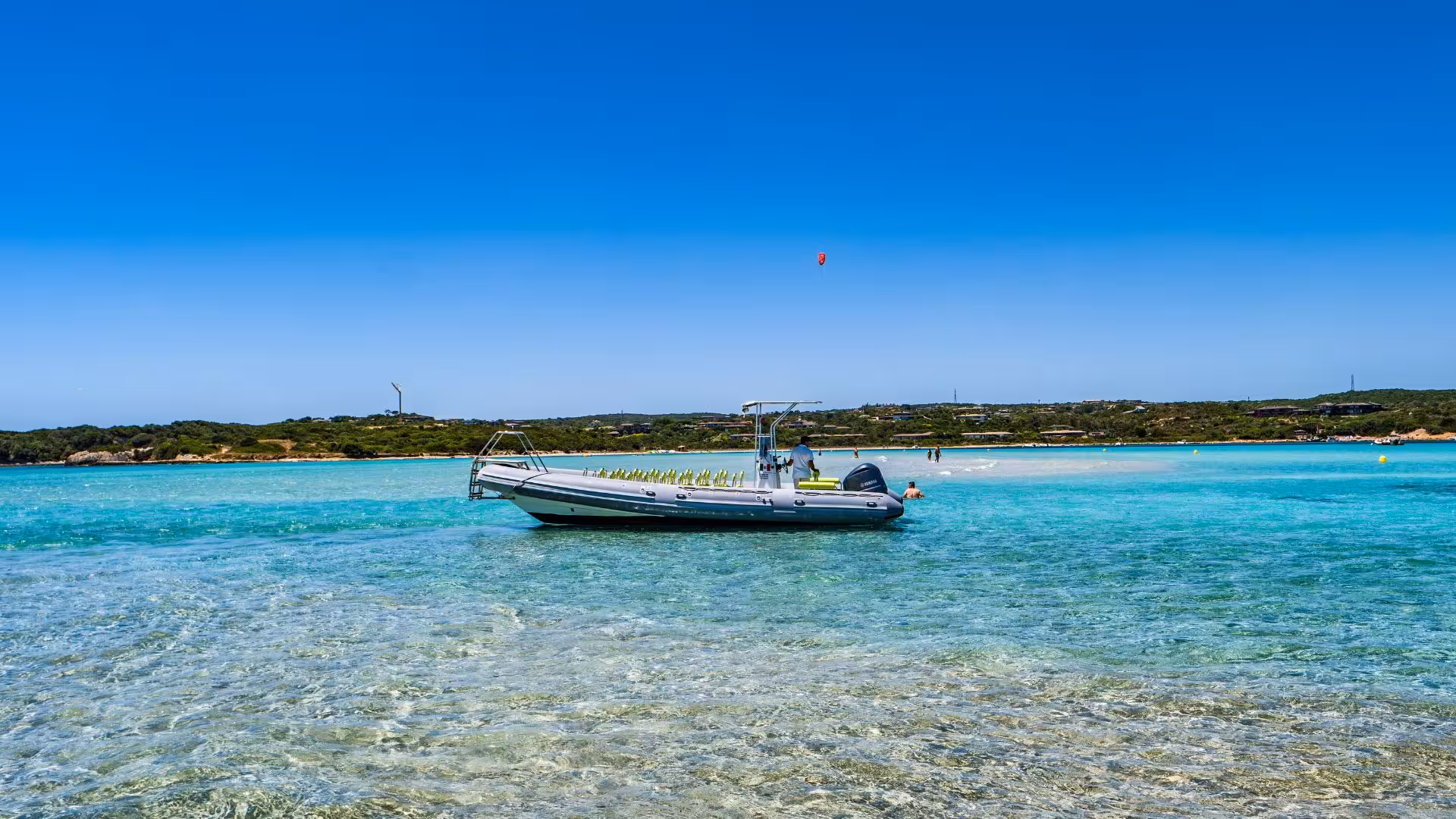 Dinghy anchored in the crystal-clear waters of southern Corsica, ideal for a scenic coastal tour.