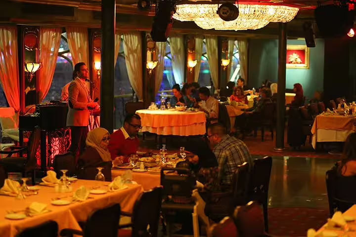 Dinner Nile cruise in Cairo with live music and dining tables, part of Egyptian Museum Citadel Coptic Cairo tour