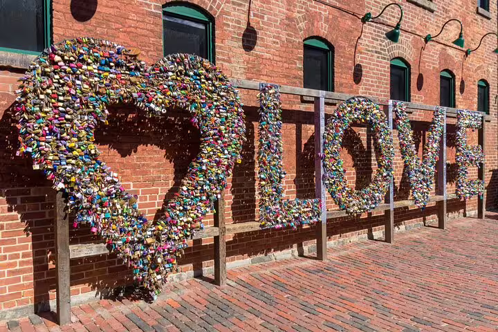 Love lock sculpture made of colorful padlocks in Toronto's Distillery District brick courtyard