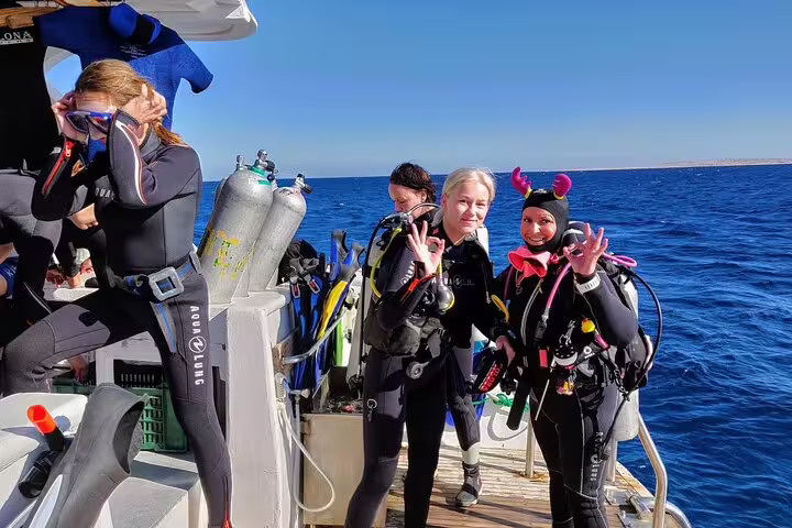 Divers in wetsuits on VIP boat deck before Ras Mohamed and White Island diving and snorkeling tour from Sharm