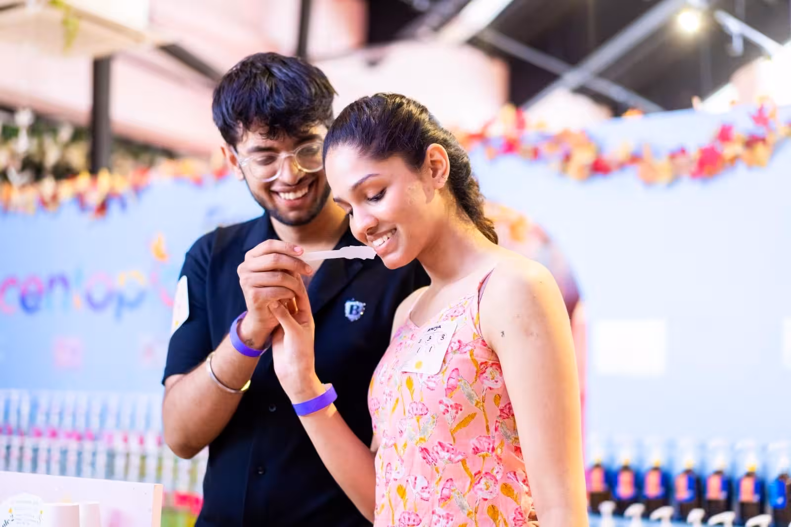 Participants enjoying DIY perfume making workshop at Sentosa, Singapore, with hands-on scent testing.