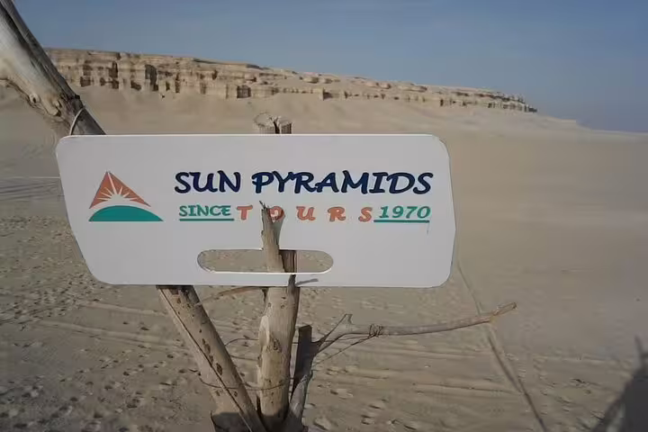 Sun Pyramids Tours sign in Egypt’s Western Desert, gateway to Djara Cave and Black & White Desert camping
