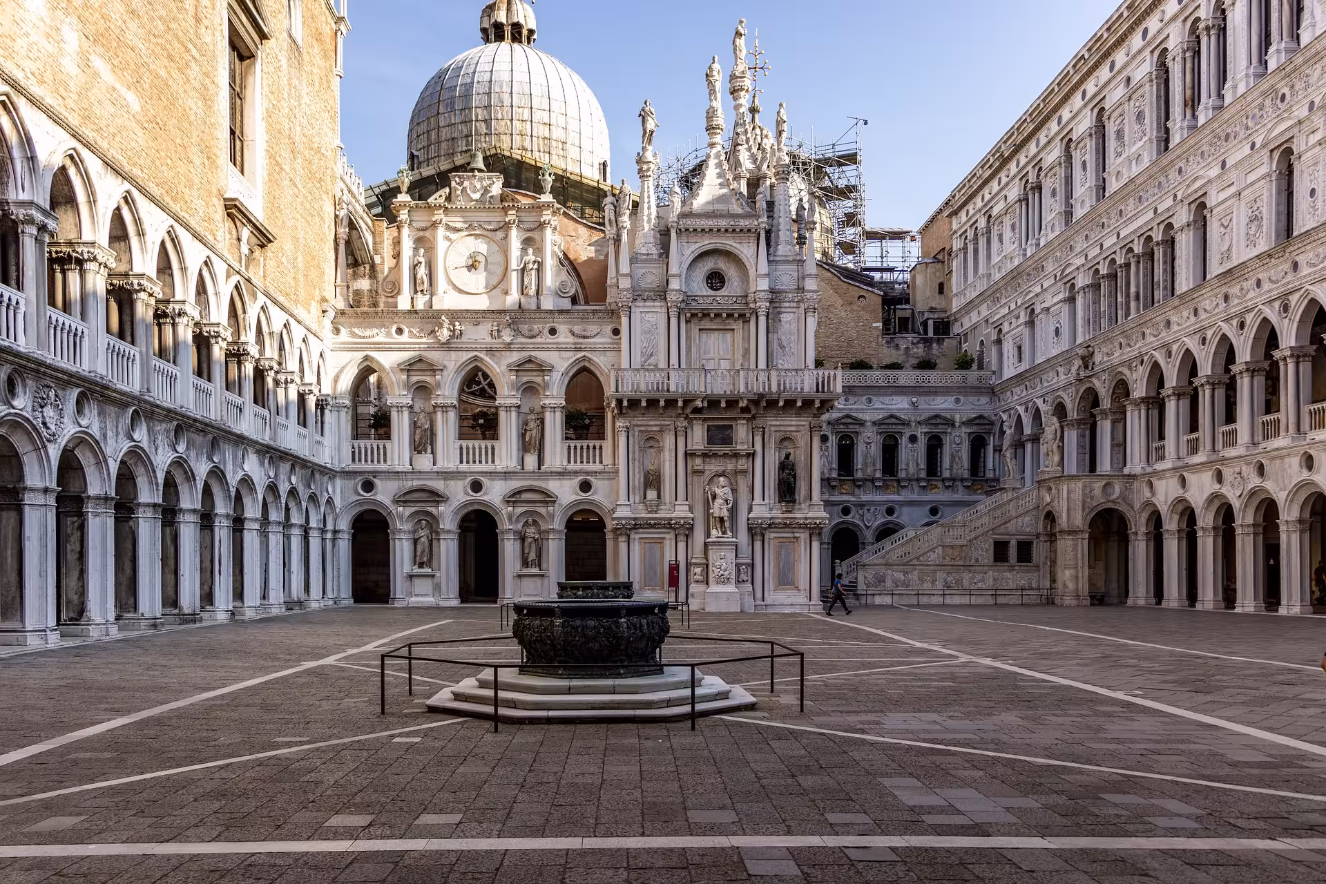 Explore the stunning architecture of The Doge’s Palace courtyard in Venice, featuring intricate stonework and historical charm.