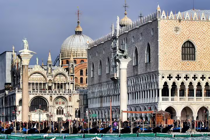 Waterfront view of Doge’s Palace and St. Mark’s Basilica with gondolas, seen on a guided small group tour in Venice, Italy