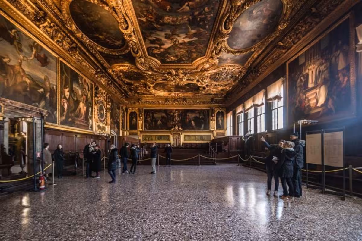 Visitors exploring the opulent interior of Doge's Palace during the Grand Tour in Venice.