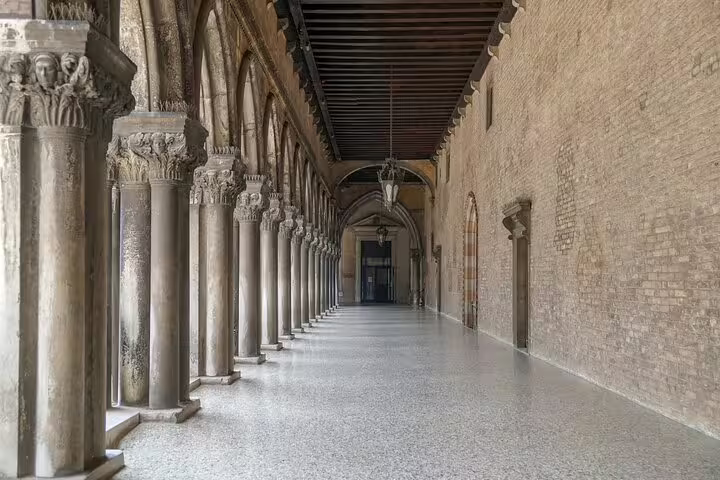 Arched stone corridor of Doge’s Palace in Venice, explored on a small group guided tour of historic Venetian architecture