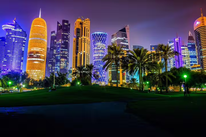 Doha skyline illuminated at night, showcasing modern architecture and vibrant city lights during the private night tour.
