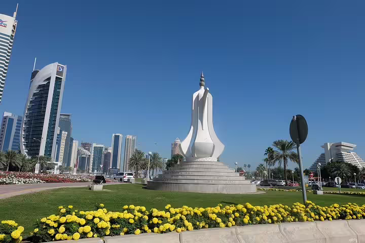 Modern skyline and iconic sculpture in a vibrant Doha cityscape on the Doha transit tour from Hamad Airport.