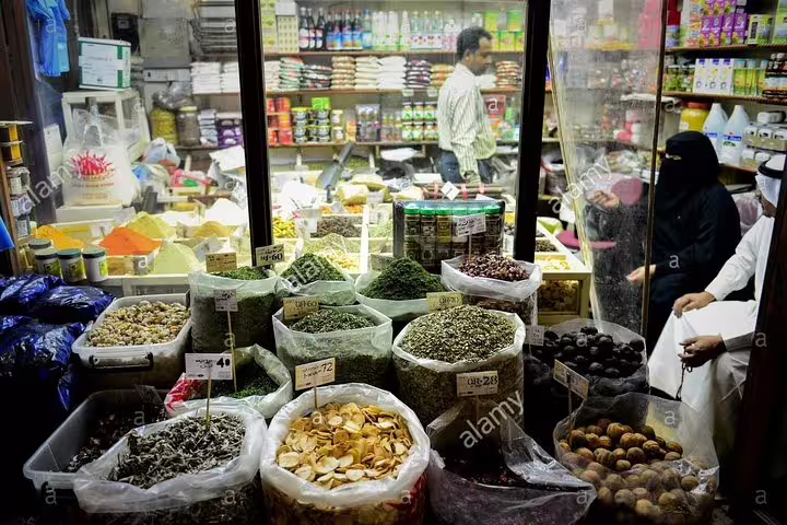 Colorful spices and herbs displayed in a vibrant market stall in Doha, ideal for a personalized city tour experience.