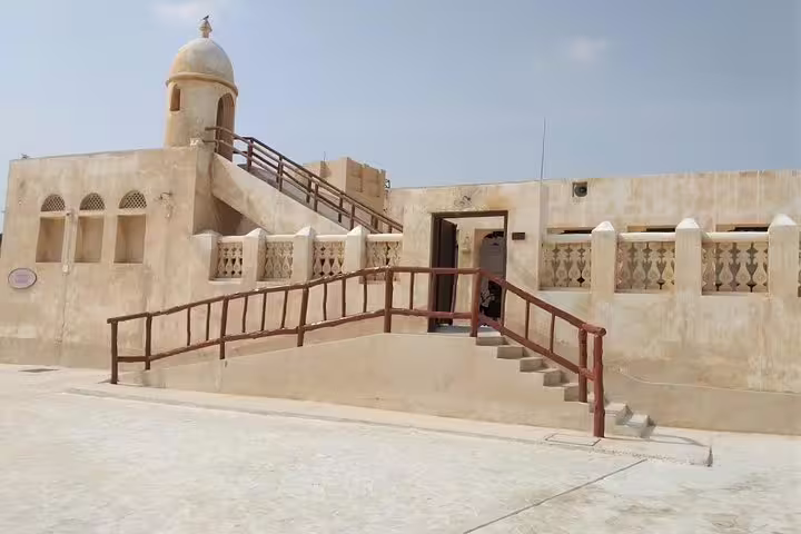 Historic architecture of a traditional Qatari building with a dome and railings, ideal for exploring on a custom itinerary.