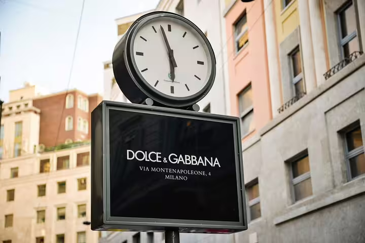 Dolce & Gabbana store sign with clock on Via Montenapoleone 4, Milan fashion district
