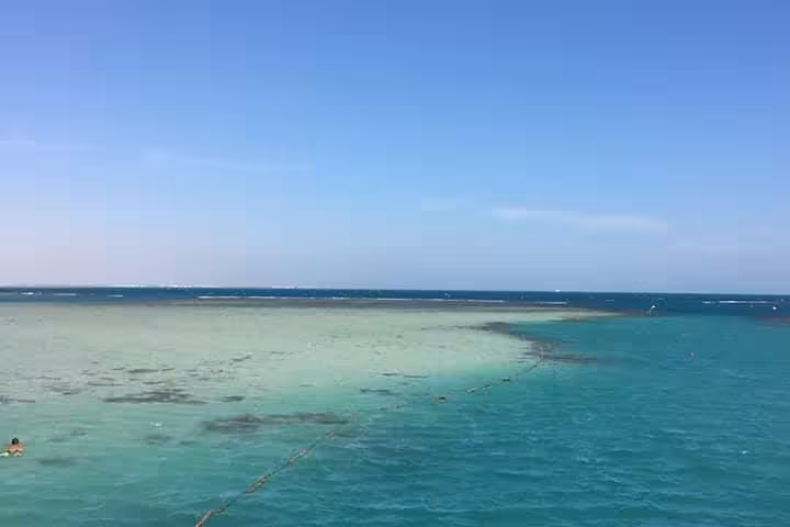 Wide view of shallow turquoise lagoon at Dolphin House National Park, Hurghada full-day snorkeling cruise