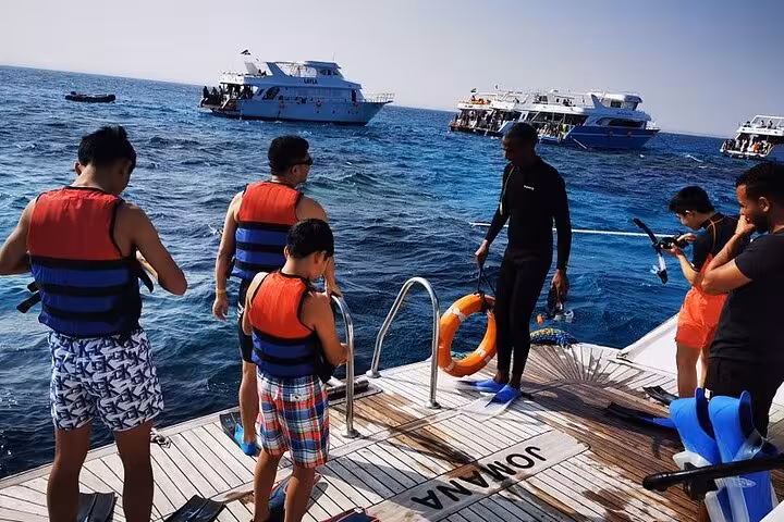 Guests gear up on the boat deck for Dolphin House National Park full-day snorkeling trip in the Red Sea