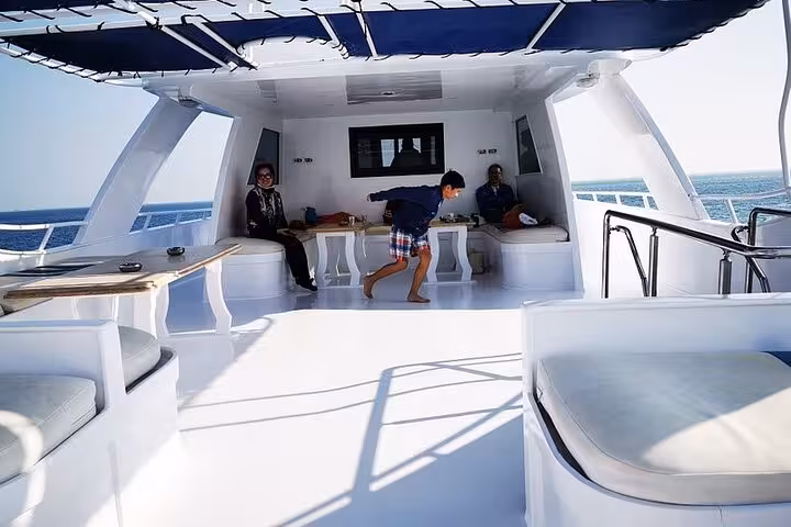 Spacious yacht lounge area on Dolphin House National Park full-day snorkeling cruise, Red Sea day trip