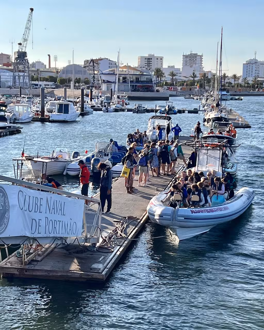 Travelers boarding RIB boats at Clube Naval de Portimão marina for a private dolphins and Ponta da Piedade Algarve tour