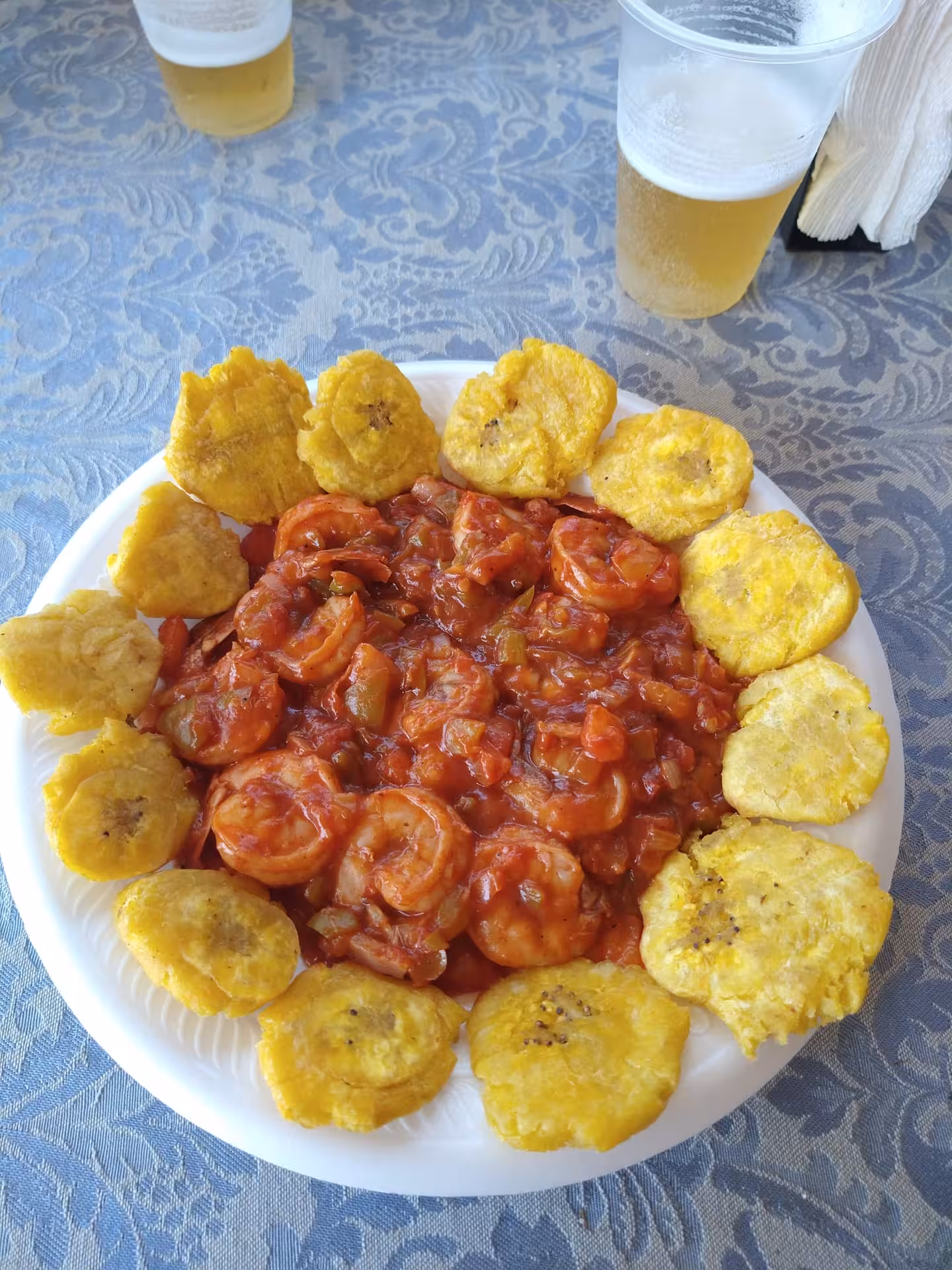 Dominican shrimp in Creole tomato sauce with crispy tostones, a flavorful local food experience on DR getaway