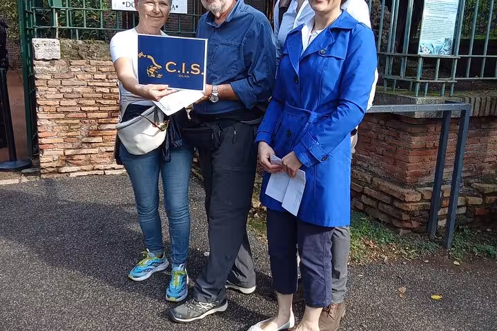 Tourists gathered at the Domus Aurea entrance, displaying a C.I.S. Tours sign, excited for the immersive Rome VR tour.