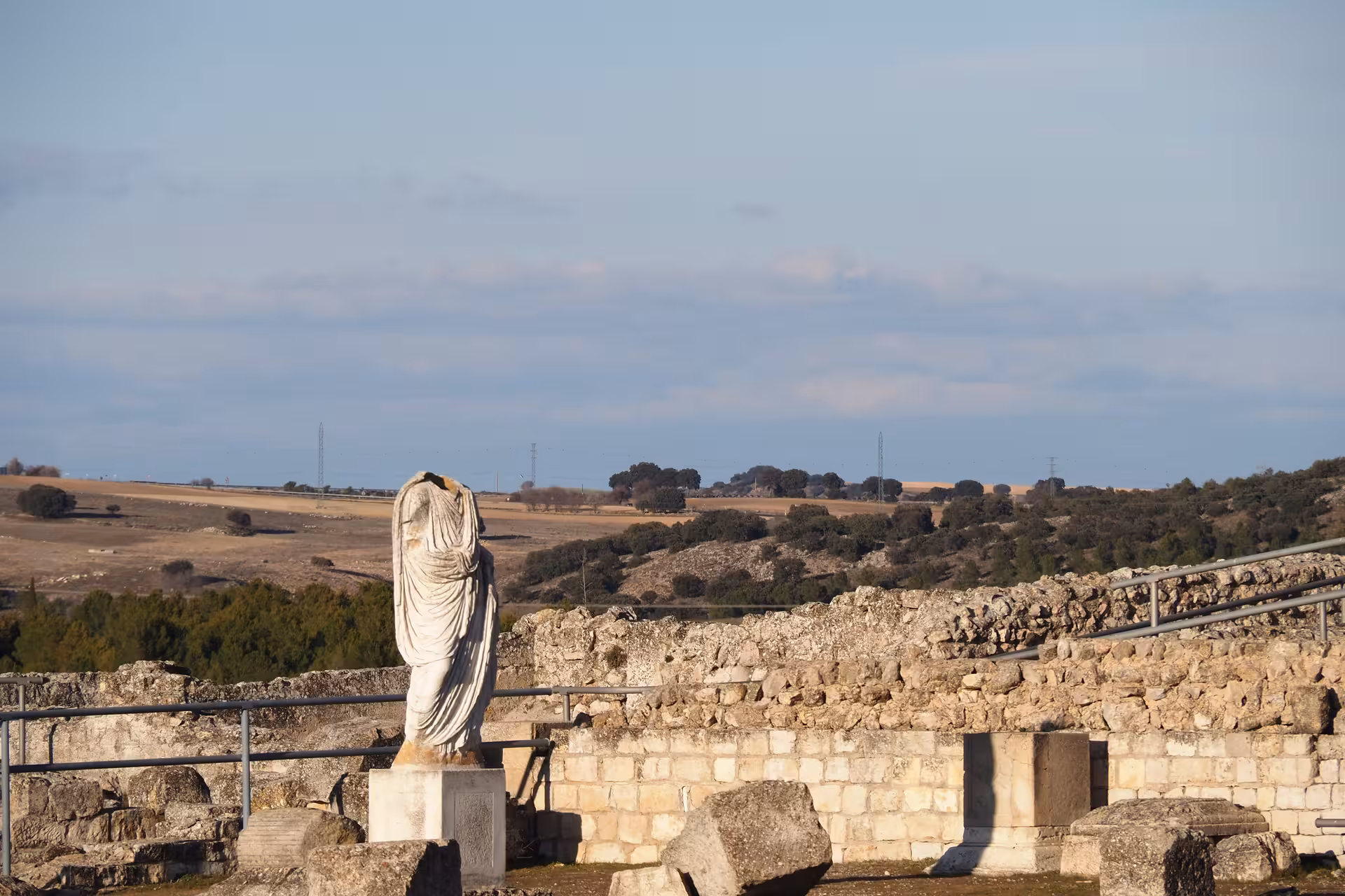 Headless marble statue overlooking countryside ruins, cultural highlight on the Don Quixote Tour in La Mancha