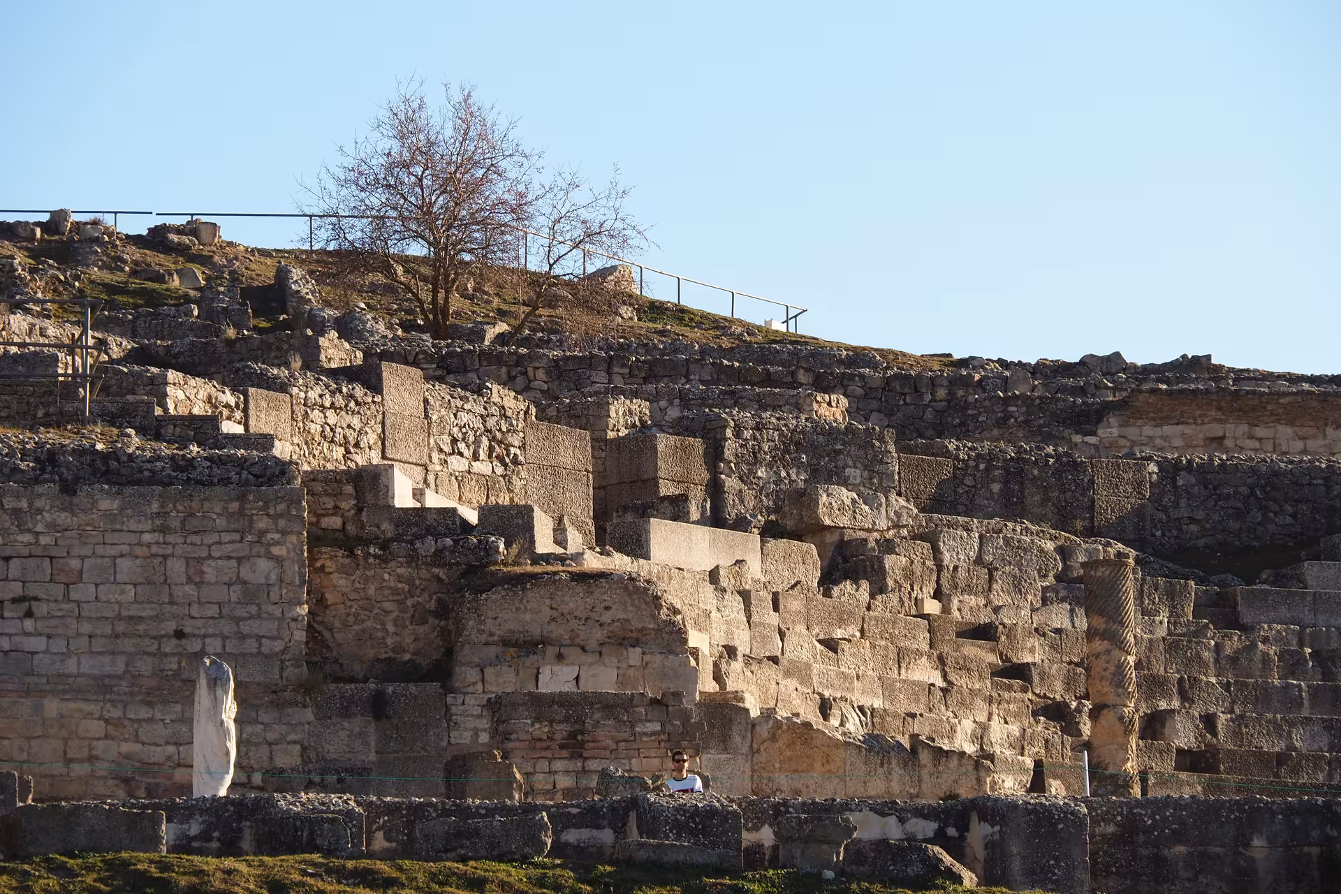 Roman amphitheater stone seating and ruins at sunset, scenic stop on the Don Quixote Tour in Spain