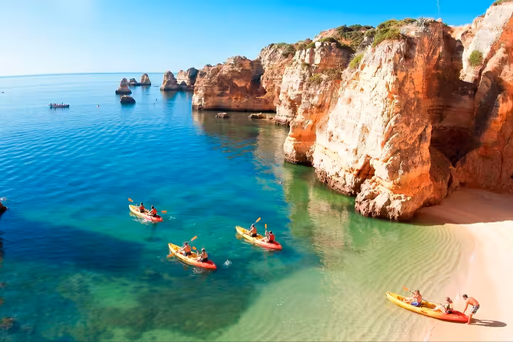 Small group kayaking along stunning Ponta da Piedade golden rock formations and crystal clear Algarve waters