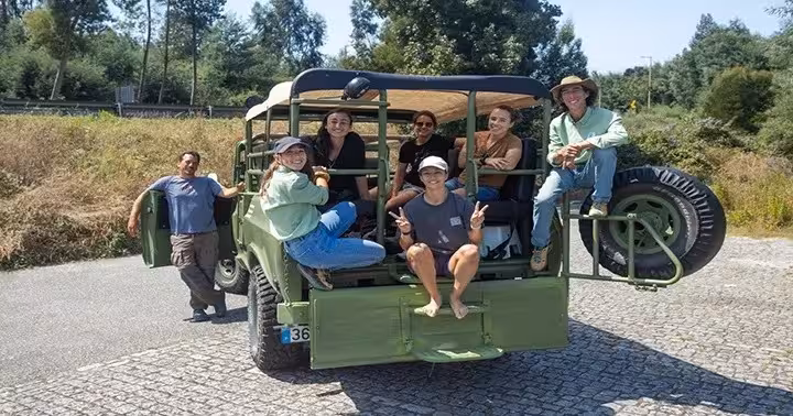 Travelers riding open-top 4x4 on Douro River scenic drive, heading to river beaches, historic mills and secret spots