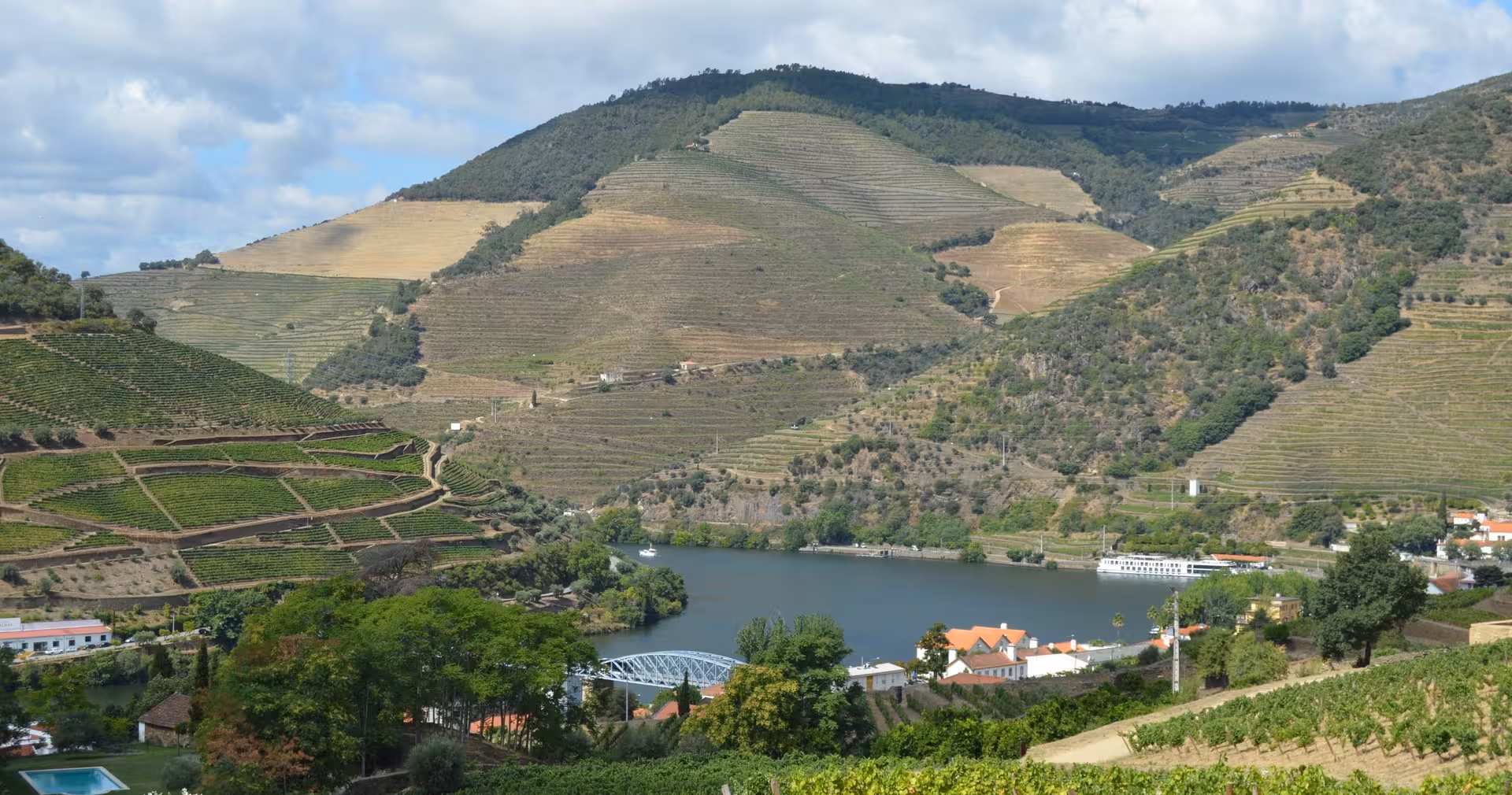Douro River cruise view of terraced vineyards and hills on a Braga to Douro Valley wine tour with lunch