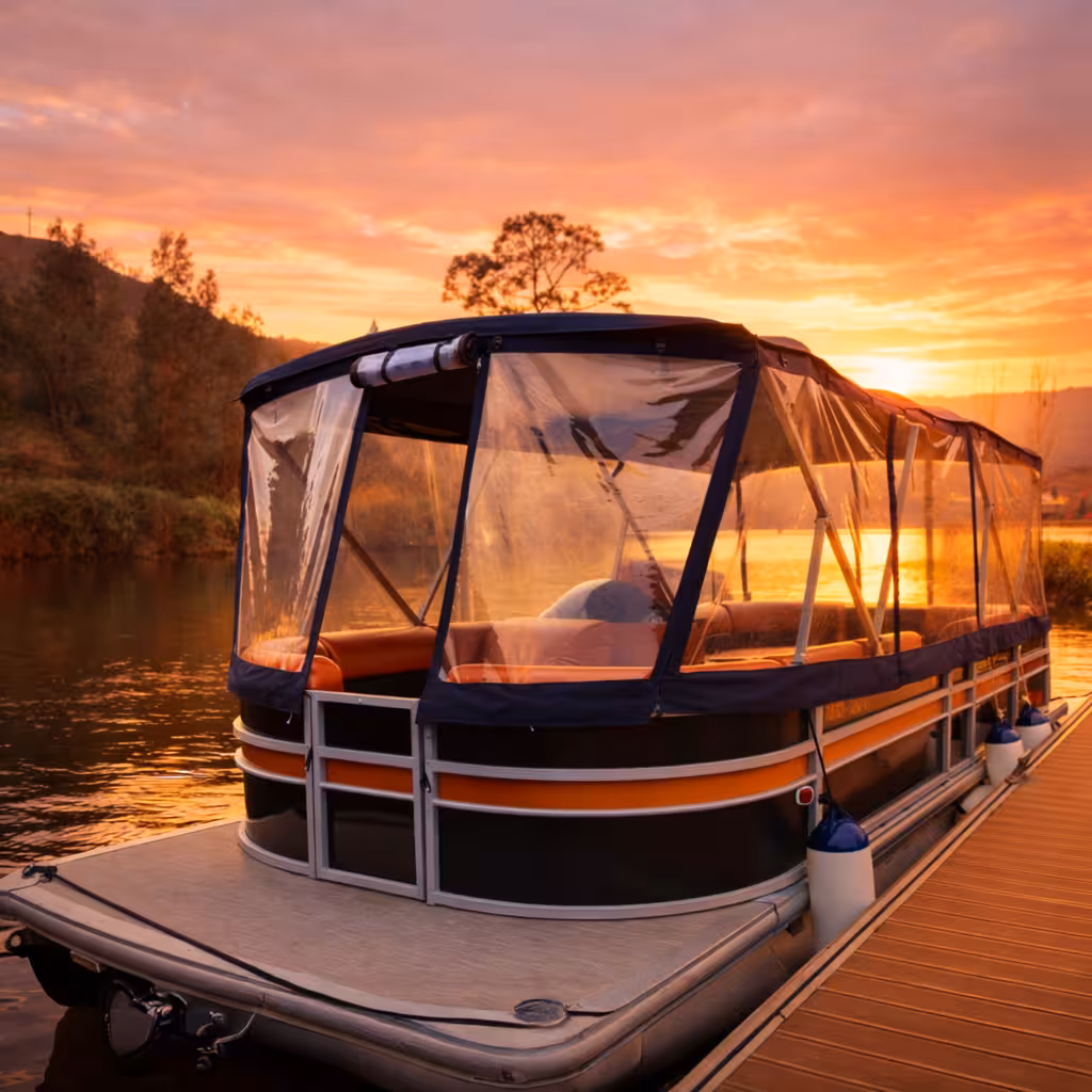 Private premium pontoon boat docked at Douro River pier during a stunning golden sunset wine tasting tour