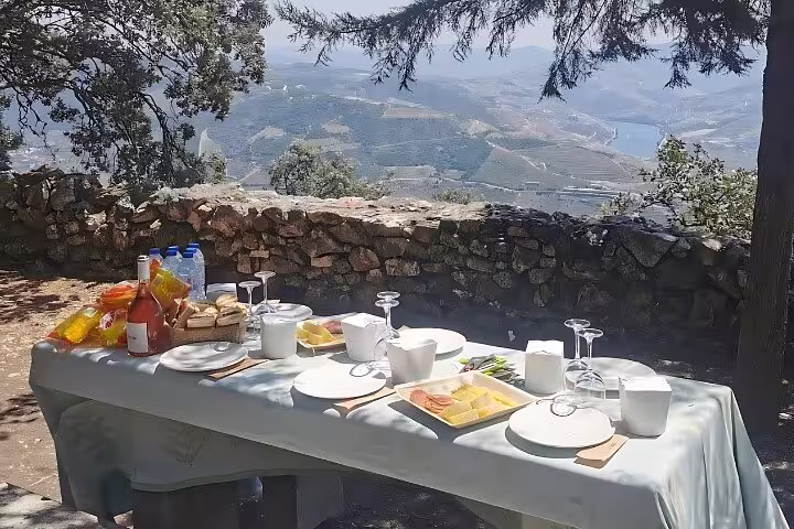 Scenic Douro Valley picnic setup with breathtaking vineyard views on a private 4x4 tour.