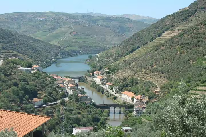 Aerial view of the picturesque Douro Valley with winding river, terraced vineyards, and quaint villages in Portugal.