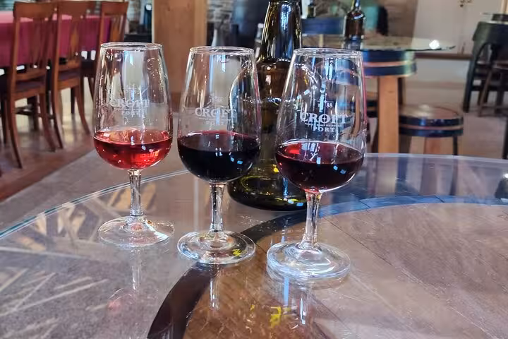 Three Croft Port wine glasses for tasting on a barrel table during a Douro Valley wine tour