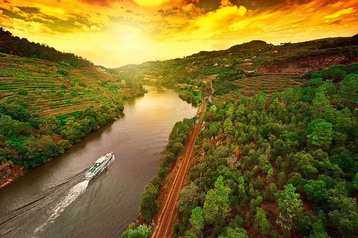 Scenic aerial view of Douro Valley at sunset, ideal for a picturesque boat return journey from Régua to Porto.