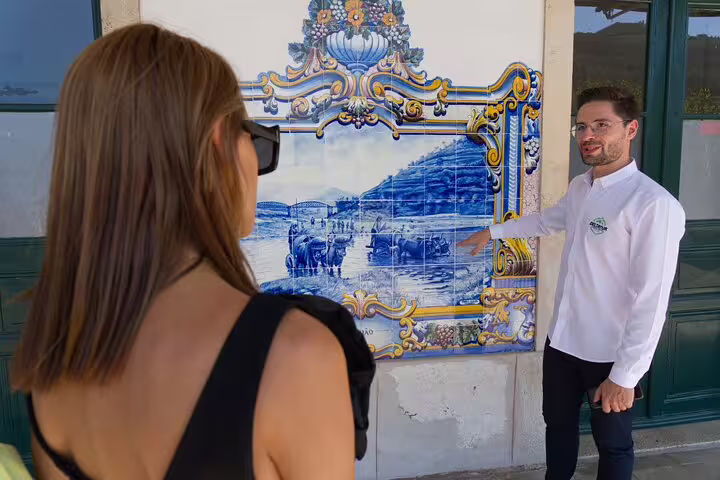 Tour guide explaining traditional azulejos at a historic site on the Douro Experience tour.