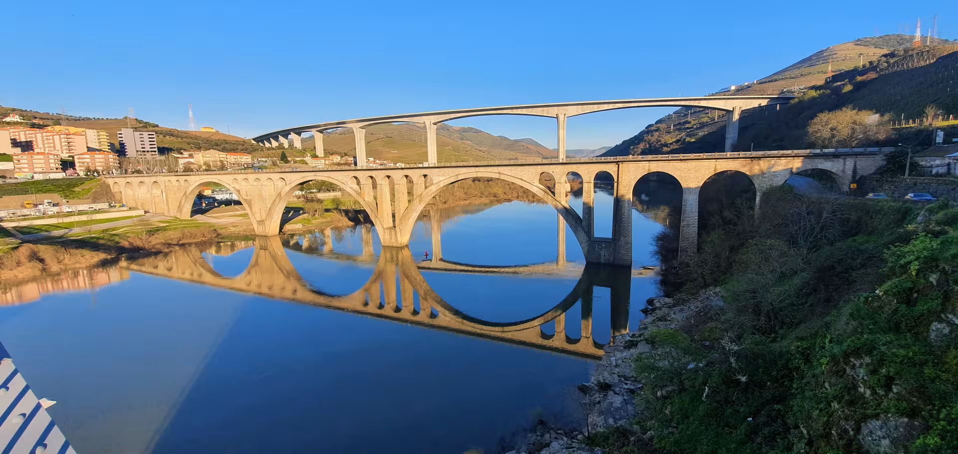 Historic arched bridge over the Douro River, scenic stop on private Douro Valley train and wine tour