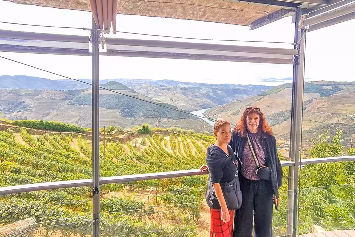 Guests at a Douro Valley vineyard viewpoint stop on the private Porto to Lisbon wine boat brunch route