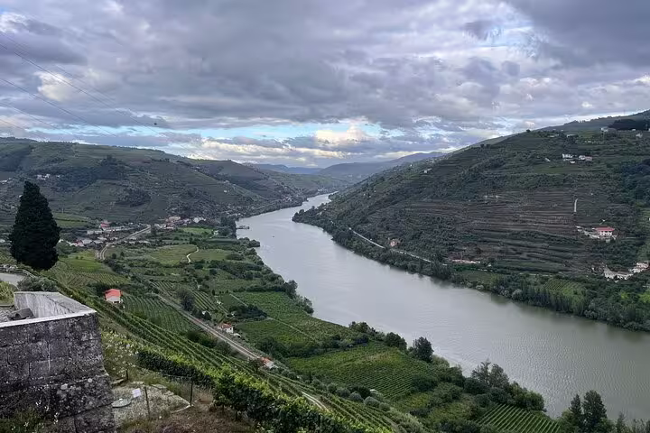 Breathtaking view of Douro River winding through lush vineyards and hills, perfect for a full-day private wine tour.