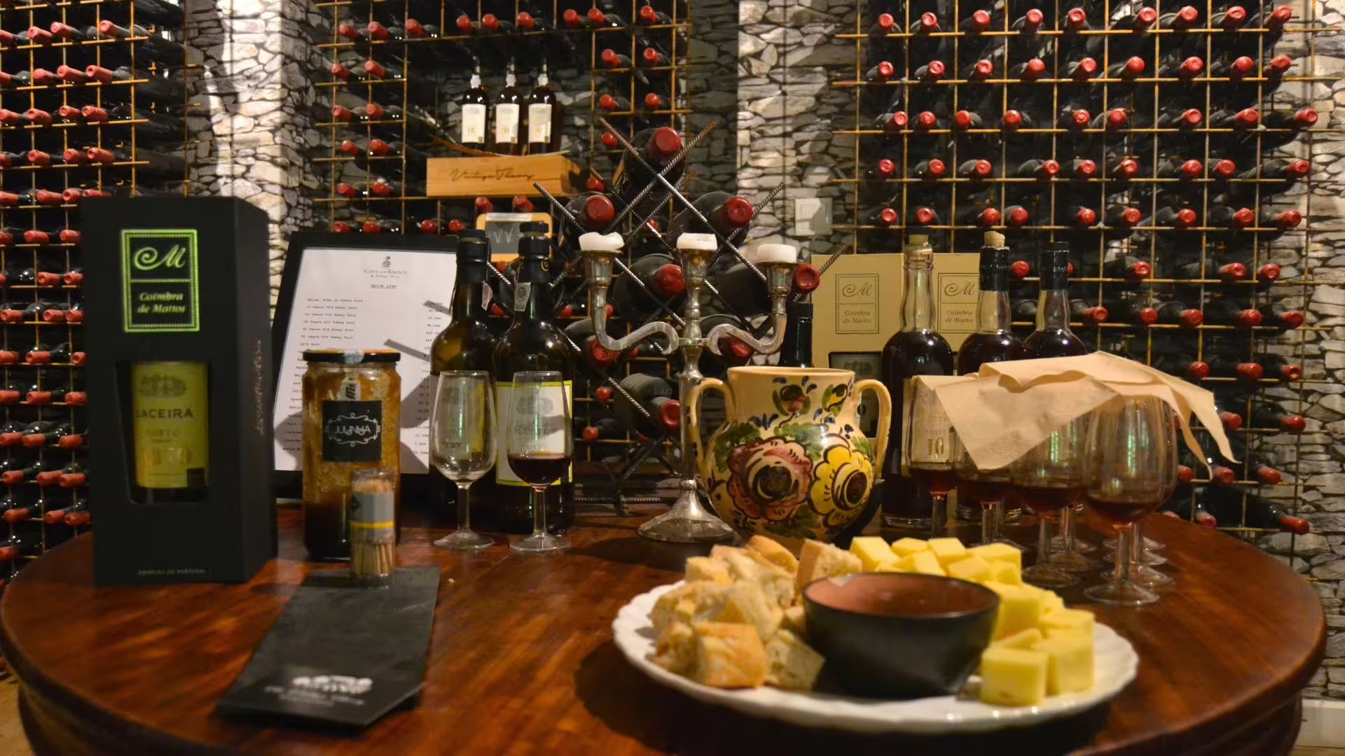 Image of a table with old ports, cheese and olive oil