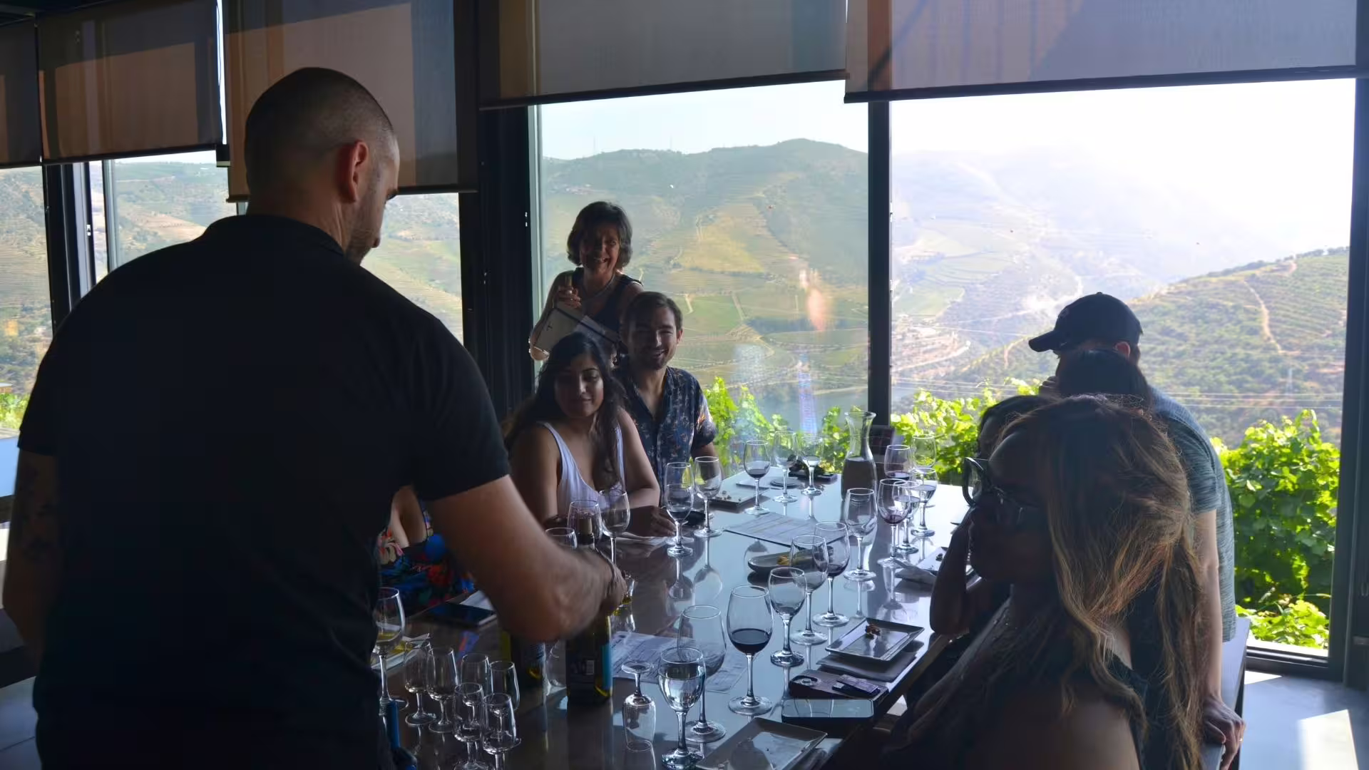 Image of a small group enjoying a wine tasting with the winery owners